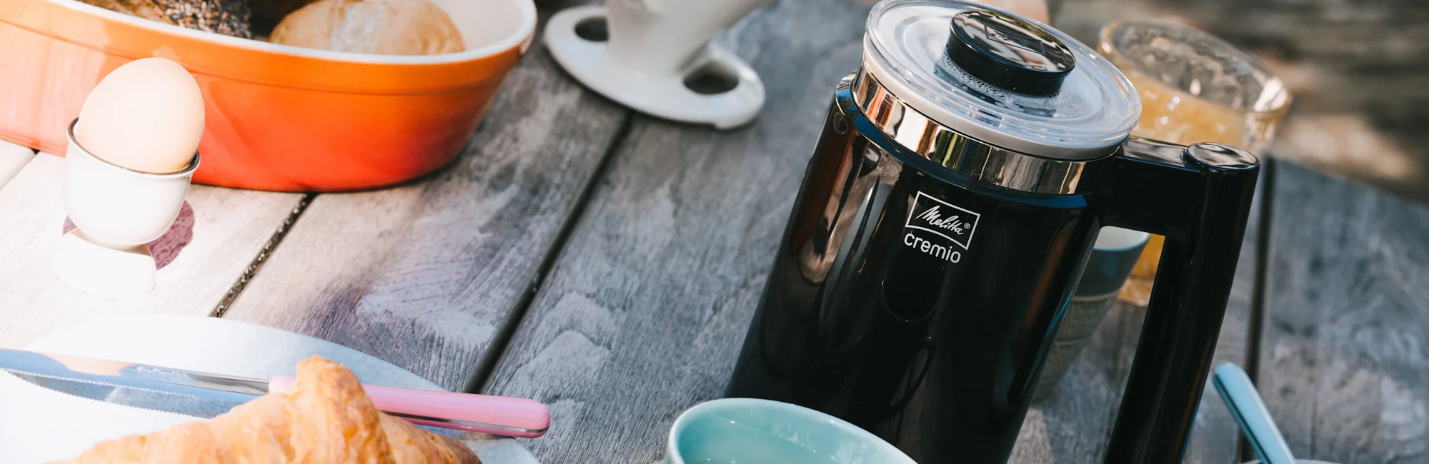 Image of our Cremio milk frother on a breakfast table