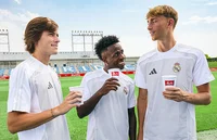 Real Madrid players holding Melitta cups and laughing 