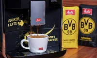 Melitta Barista Borussia Dortmund coffee beans and a cup of Melitta coffee made