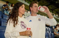 Real Madrid fans standing on the stands while drinking Melitta coffee