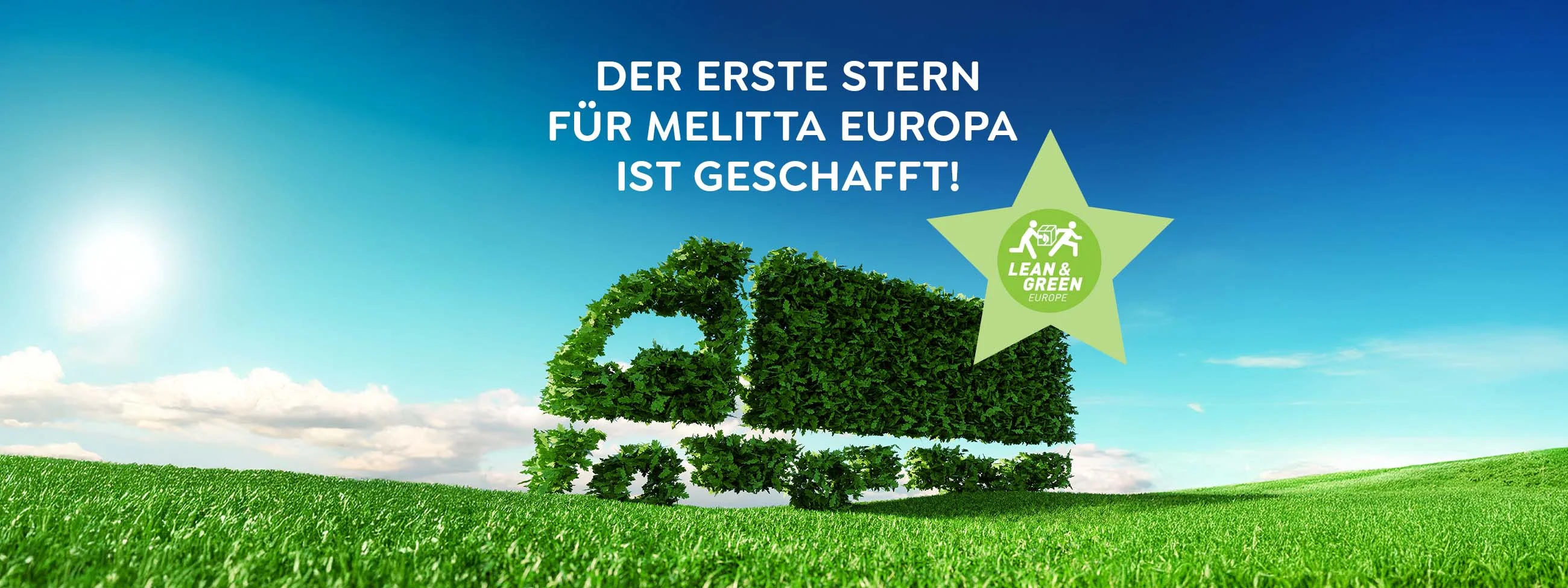 grüner LKW auf grüner Wiese mit einem Lean and Green Stern