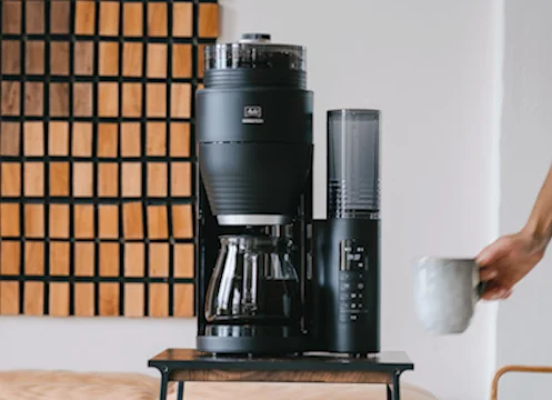 Aroma Fresh on a wooden stool where a model intends to place a cup underneath.