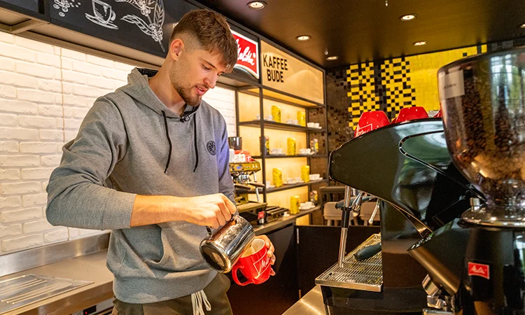 A Borussia Dortmund footballer pouring a cup of Melitta coffee